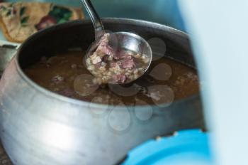 Cooking meals in a Russian stove, soup with meat and groats