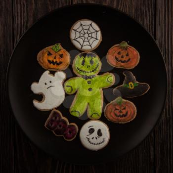 Homemade delicious ginger biscuits for Halloween on wooden table