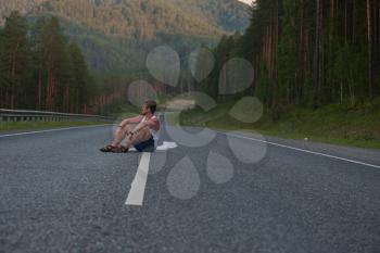 Man sitting on the beauty road in mountain