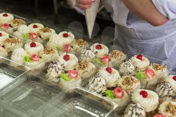 Manual cakes production on factory