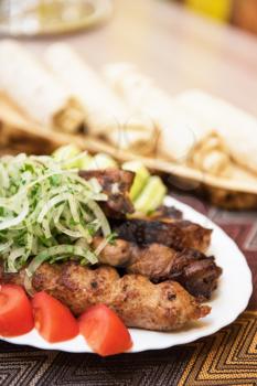 Grilled shish kebab or shashlik meat with vegetables