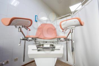 Gynecological cabinet with chair and other medical equipment in modern clinic