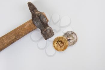 Bitcoin coins with hammer on the white background