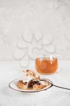 Cakes with tea on white background
