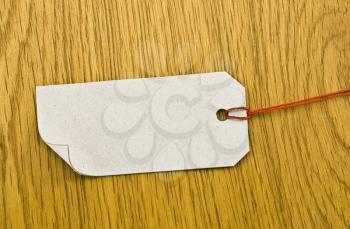 Royalty Free Photo of a Blank Tag on a Wooden Background