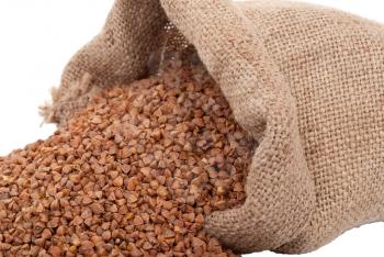 Royalty Free Photo of a Burlap Sack Full of Buckwheat Pouring Out