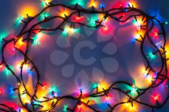 Christmas lights frame on dark blue background