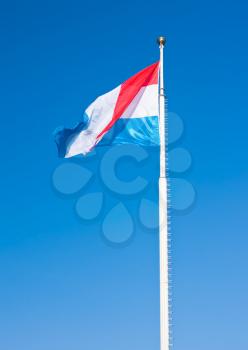 Flag of Luxembourg over blue sky. This photo is taken in Luxembourg