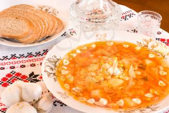 Ukrainian food - borsch, vodka, bread on towel