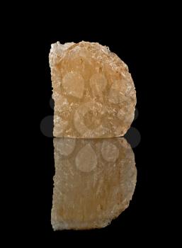Block of rock salt mineral over black
