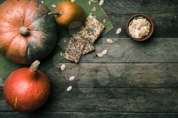 Rustic style pumpkins with cookies and seeds on wood. Autumn Season food photo