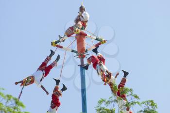 Flying Mayans performing in front of the tourists.