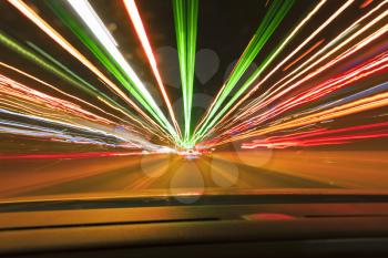 Long exposure speed car lights trails on a night highway.