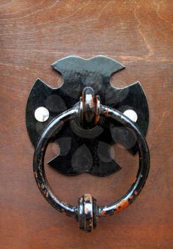 ring doorknocker on wood background                               