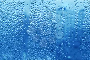 Water drops on glass naural blue texture