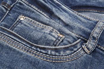 Texture of dark blue jeans closeup