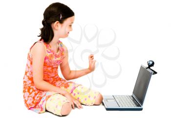 Royalty Free Photo of a Young Girl Sitting on the with a Laptop