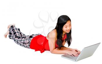 Royalty Free Photo of a Teenage Girl Lying on the Floor Using a Laptop