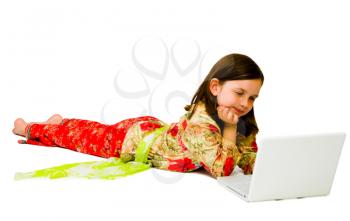 Royalty Free Photo of a Young Girl on the Floor Using a Laptop