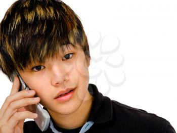 Portrait of a teenage boy talking on a mobile phone isolated over white