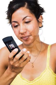 Woman text messaging on a mobile phone isolated over white