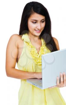 Young woman using a laptop and posing isolated over white