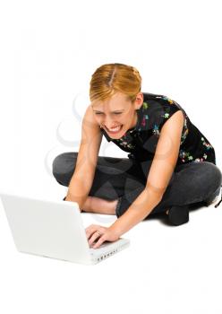 Close-up of a woman using a laptop and smiling isolated over white