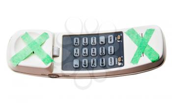 Cordless phone with adhesive tape on it isolated over white