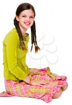 Happy girl kneeling and posing isolated over white