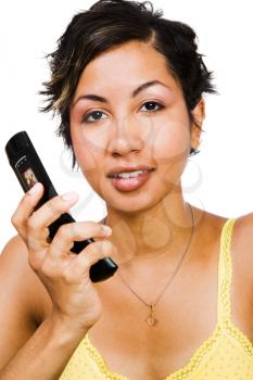 Portrait of a woman holding a mobile phone isolated over white