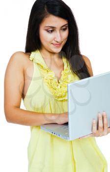 Woman using a laptop and posing isolated over white