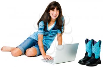 Latin American teenage girl using a laptop and smiling isolated over white