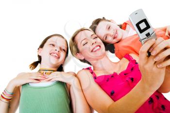 Woman lying with her daughters and photo messaging isolated over white