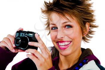 Beautiful woman photographing with a camera and smiling isolated over white