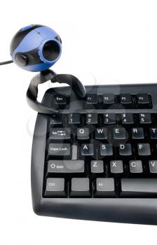 Webcam on a computer keyboard isolated over white