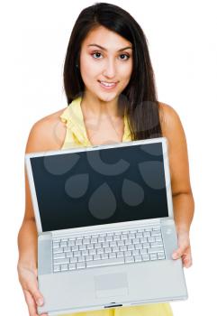 Smiling woman showing a laptop and posing isolated over white