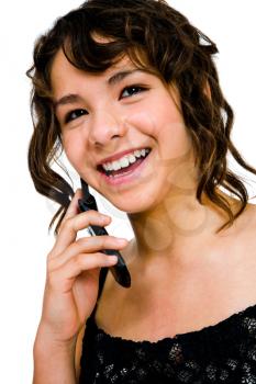 Beautiful teenage girl talking on a mobile phone isolated over white
