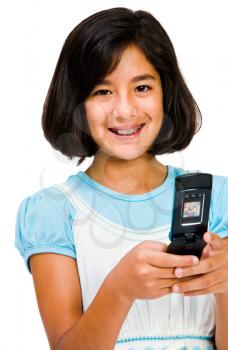 Girl text messaging on a mobile phone and smiling isolated over white