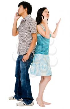 Girlfriend and boyfriend talking on mobile phones isolated over white
