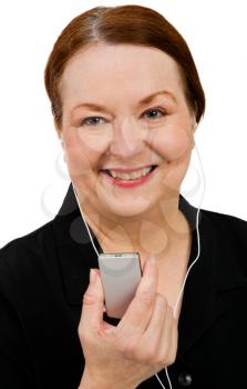 Close-up of a woman listening to music on MP3 player isolated over white