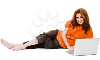 Happy woman using a laptop and posing isolated over white