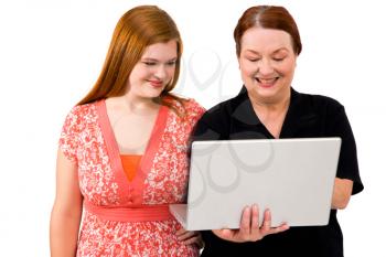 Women using a laptop and smiling isolated over white