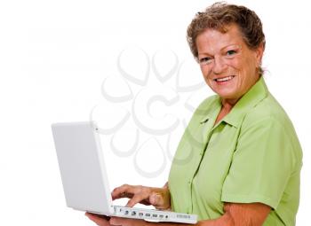 Confident woman using a laptop and posing isolated over white