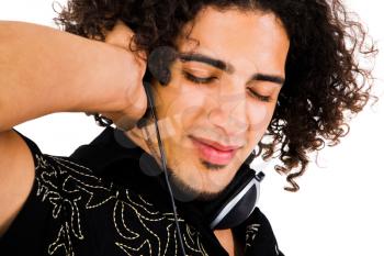 Close-up of a man wearing headphones and listening to music isolated over white