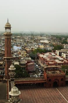 Minaret of a mosque with cityscape, Jama Masjid, Delhi, India