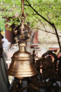 Close-up of a bell hanging at a market stall, New Delhi, India