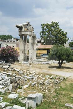 Ruins of a gate with buildings in the background, Roman Agora, Athens, Greece