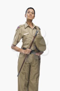 Portrait of a female police officer holding a stick