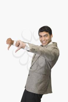 Businessman showing thumbs down and smiling