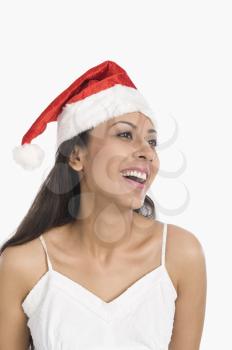 Close-up of a woman wearing a Santa hat and laughing